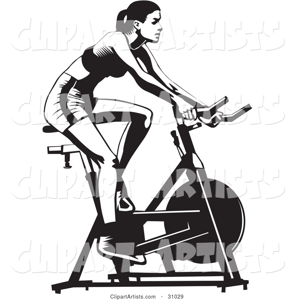 Healthy Woman Exercising on a Stationary Bicycle in a Gym