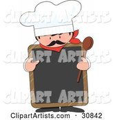 Male Chef with a Mustache, Wearing a Hat and Holding a Wood Spoon While Pointing to a Blank White Chalkboard