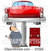 White Male Mechanic Holding a Wrench and Working on a Red Classic Car up on a Lift in a Garage