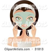 Beautiful Brunette Caucasian Woman with Green Eyes, Facing Front and Touching the Green Facial Mask on Her Face