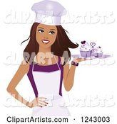 Beautiful Brunette Female Baker Holding a Tray of Purple Cupcakes