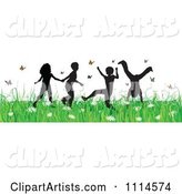 Carefree Silhouetted Children Playing in Grass and Butterflies
