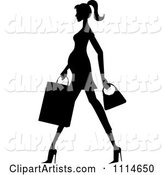 Slender Silhouetted Pregnant Woman Walking with a Shopping Bag and Purse