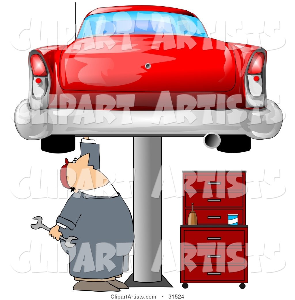 White Male Mechanic Holding a Wrench and Working on a Red Classic Car up on a Lift in a Garage