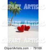 Couple of Red Hearts near Palm Trees on a Tropical Beach