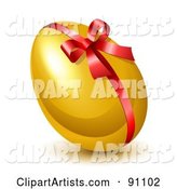 Shiny Golden Easter Egg with a Red Ribbon and Bow