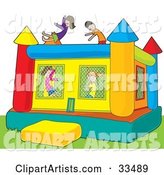 Boys and Girls Jumping in a Colorful Inflatable Bouncy Castle on Grass