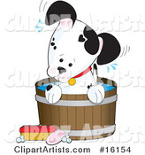 Cute Little Dalmatian Puppy Dog with a White Base and Black Spots, One of Them Resembling a Heart, Sitting in a Barrel of Water and Tilting Its Head While Taking a Bath