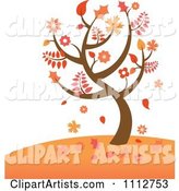 Autumn Tree with Falling Leaves on a Hill