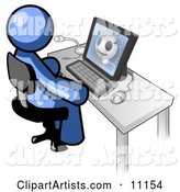 Blue Doctor Man Sitting at a Computer and Viewing an Xray of a Head