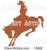 Brown Silhouette of a Cowboy Riding a Bucking Bronco in a Rodeo