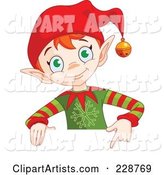 Christmas Elf Holding and Pointing to a Blank Sign