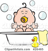Happy Baby Playing in Bubbles in a Tub with a Towel and Rubber Ducky at the Side