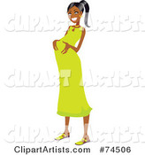 Happy Pregnant Black Woman Rubbing Her Belly in a Green Dress