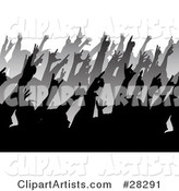 Rows of Black and Gray Silhouetted People Holding Their Hands up in a Crowd at a Music Concert