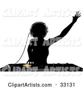 Silhouetted Female DJ Holding Her Arm up in the Air, Wearing Headphones and Mixing a Record